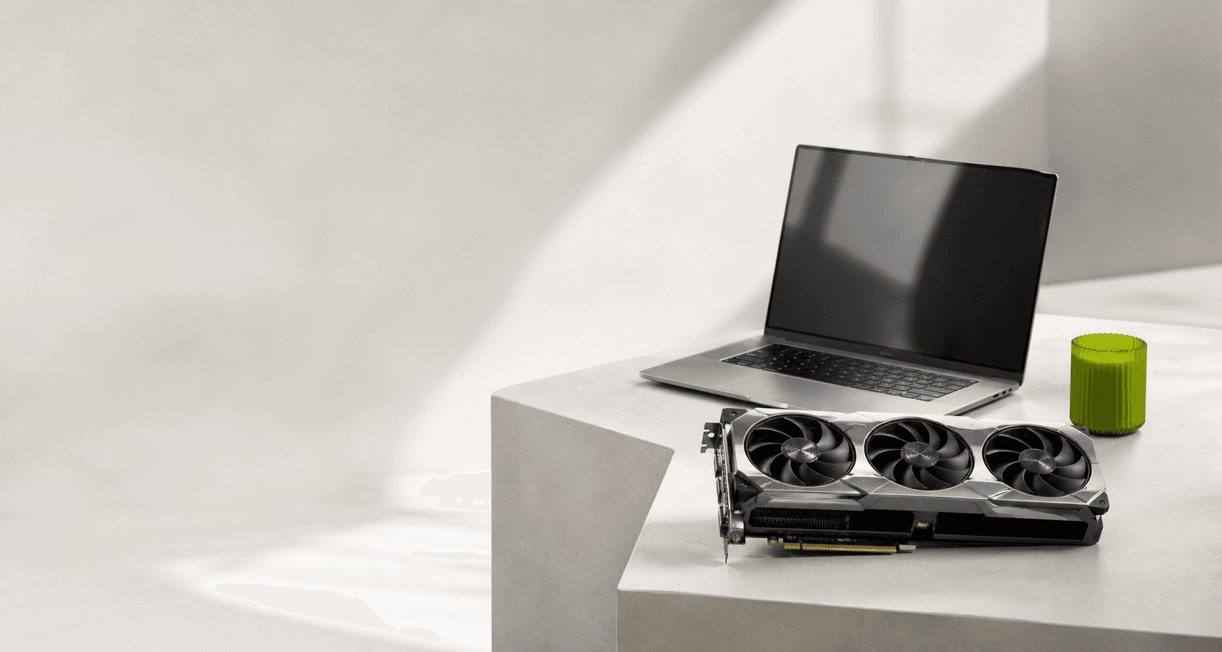 Laptop and graphics card on a clean desk
